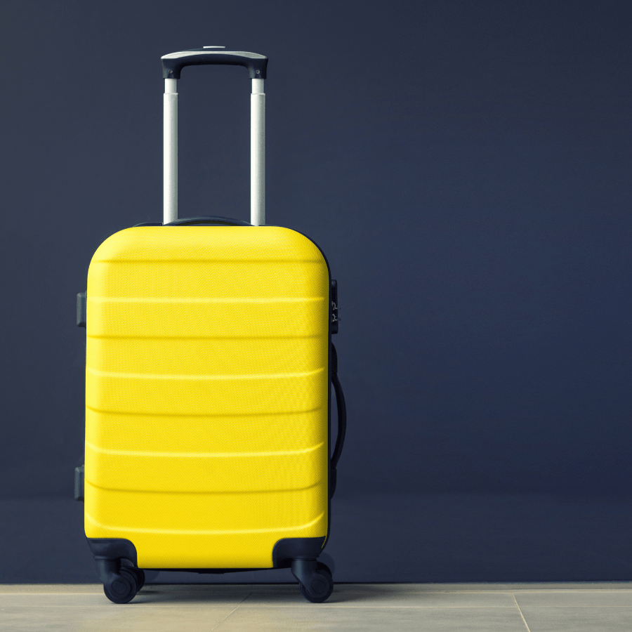 yellow wheeled suitcase with handle in front of a blue background