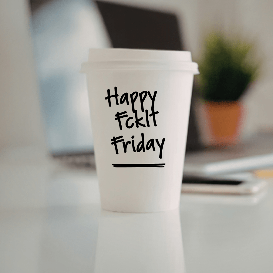 A paper coffee cup sitting on a counter with "Happy FckItFriday" written on it